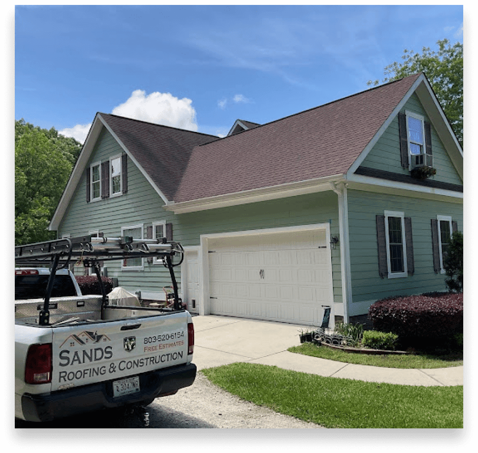 Sands Roofing & Construction branded truck at a completed roofing project in Lexington, SC